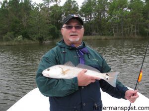 John Cashwell, of Raleigh, with a slot red drum he hooked on a popping cork rig while fishing the Neuse River near Oriental with Capt. Gary Dubiel of Spec Fever Guide Service.