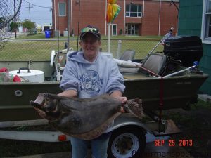 Barbara Smith with an 8 lb. flounder that bit a large finger mullet in Snow's Cut while she was fishing with Harry Gierszewski.