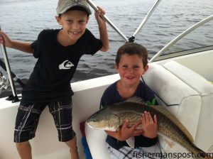 Thomas Snider (age 6) and Mason Hodges (age 9) with a red drum they hooked near Carolina Beach while fishing with their fathers.