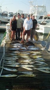 Alice and Matt Buck and friends with limit catches of dolphin and yellowfin tuna along with a wahoo they hooked while trolling offshore of Oregon Inlet with Capt. Lee Collins and mate Bo Davenport on the charterboat "Strike 'Em" out of the Oregon Inlet Fishing Center.