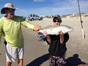 Ballard Earley, of Youngsville, NC, with his first red drum, a 33" fish that bit a chunk of menhaden near the point at Bogue Inlet while he was fishing with Bruce Koonce.
