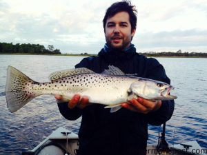 Jason Fralin with a speckled trout that fell for a topwater plug in the lower Cape Fear River.
