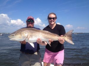 Capt. Mark Dickson, of Shallow Minded Inshore Fishing Charters, and Barb Pennington, from NY, with a 44" red drum that bit a live mullet in Little River Inlet.