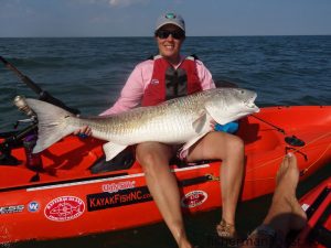 Lisa Alderman with a 47" red drum that bit a chunk of fresh menhaden just off the beach at Corolla while she was fishing with her husband, Capt. Rob Alderman of Outer Banks Kayak Fishing.