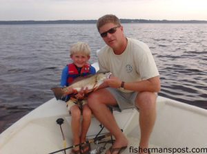 Will (age 6) and Brent Glover with a puppy drum that bit a Gulp bait under a popping cork in the Pamlico River.