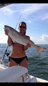 Fran Pacheco, of Wilmington, with an over-slot red drum she hooked in Carolina Beach Inlet on a live minnow.