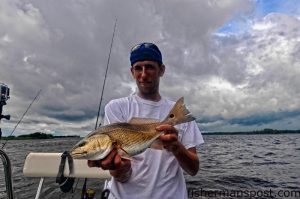 Marine artist Hayden Hammond with a red drum that bit a live menhaden in the Cape Fear River while he was fishing with Luke Donat and Scott Hampton.