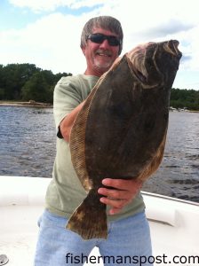 Calvin Sears with a 6 lb., 9 oz. flounder that fell for a live finger mullet near Southport while he was fishing with his sons Neal and Kyle.