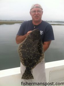 Paul Tew, of Zebulon, NC, with a 6.5 lb. flounder that bit a live finger mullet in a creekmouth behind Emerald Isle.