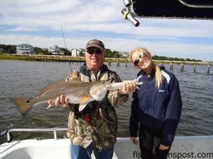 Rob and Kristen Young with a 24" red drum that struck a live finger mullet near Carolina Beach Inlet while he was fishing with Capt. Chris Bryan of Sunrise Inshore Fishing Charters.