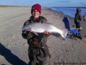Johnny Fairbanks (age 10), of Frisco, NC, with a 24" puppy drum he hooked in the Frisco surf while fishing with family.