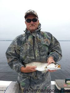 Jimmy Hawley, of Rock Ridge, NC, with a speckled trout that bit a root beer Gulp shrimp along a Pungo River shoreline near Belhaven.