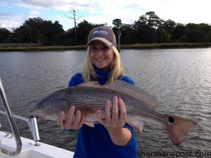 Lori Little with her first slot red drum, a 22" fish that bit a Carolina-rigged menhaden in Bradley Creek.