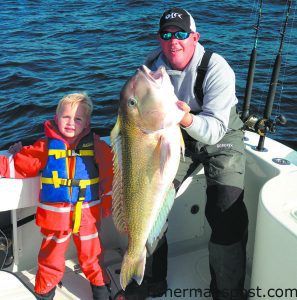 Brayden (age 4) and Capt. Brant McMullan, of the Ocean Isle Fishing Center, with a 35 lb. golden tilefish they hooked while bottom fishing 90 miles off Ocean Isle Beach.