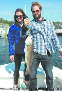 Jennifer and Mike, from Oregon, with a red drum they hooked near a Carteret County dock while fishing with Capt. Chris Kimrey of Mount Maker Charters.