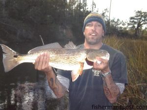 Warren Knowles, of Wilmington, with a red drum that bit a white soft plastic bait near Bald Head Island.