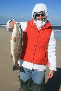 Stacie Turner, of Roanoke, VA, with a puppy drum that fell for cut shrimp in the surf off Ramp 4 near Oregon Inlet while she was fishing with Dan Shockley and her mother, Betty Wright. Photo courtesy of TW's Tackle.