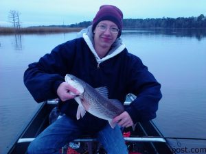 Jacob Cooper, of Burgaw, NC, with a 20" red drum that bit a chunk of mullet while he was fishing the Brunswick River.