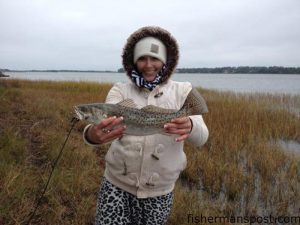 Katie Klug with her first speckled trout, an 18" fish that bit a live menhaden near Southport in early January.