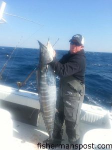 Capt. Brant McMullan, of Ocean Isle Fishing Center, with a 62 lb. wahoo that bit a ballyhoo under a Blue Water Candy JAG while he was trolling the break off Ocean Isle aboard the "Team OIFC."