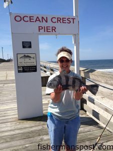 Kathie Brown, of Oak Island, with a 3 lb. black drum she hooked while bottom fishing from Ocean Crest Pier.