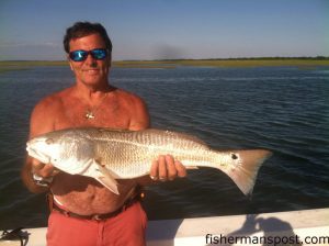Wayne Herndon, of Emerald Isle, with a tagged 29" red drum he caught and released in a marsh behind Bear Island after it struck a chunk of mullet. He was fishing with Capt. Rob Koraly of Sandbar Safari Charters.