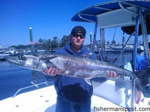 Chris Earnes, of Caswell, NC, with a king mackerel that bit a live bait near Oak Island while he was fishing with Capt. Greer Hughes of Cool Runnings Charters.