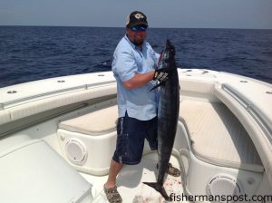 Ash Cook, of Ft. Mill, SC, with a 50 lb. wahoo that bit a skirted horse ballyhoo near the Steeples while he was fishing out of Holden Beach aboard the "Pokey."