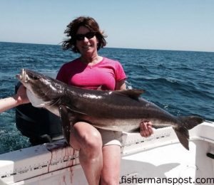 Robin Stewart, of TW's Bait and Tackle, with a 50+ lb. cobia that was one of 23 caught on sight-cast eels and bucktails while she was fishing with her son Justin aboard the "Justin Time." Also aboard were her husband T.W., Lewis Boyd, and Andrew Norris.