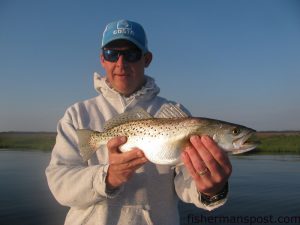Matt Godwin, of Beaufort, with a speckled trout that bit a topwater plug in the lower Neuse River while he was fishing with Capt. Gary Dubiel of Spec Fever Guide Service.