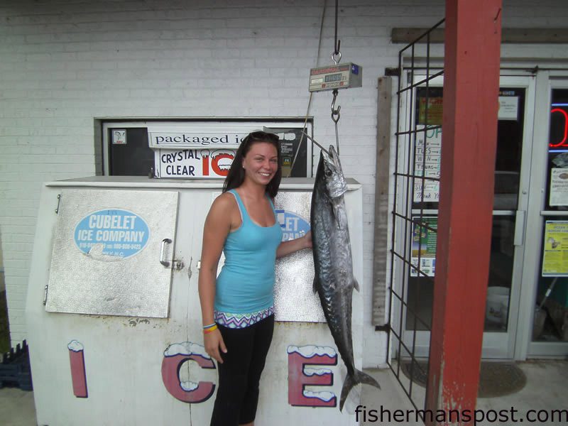Kristina Steenborg, of Southport, NC, with a 31 lb. king mackerel that struck a live menhaden beneath a kite off Oak Island.