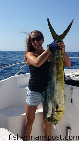 Nicole St. Cyr, of Southport, with a 26 lb. dolphin she hooked while trolling 60 miles off Bald Head Island with Patrick Jones and Andy and Boyce Broadwell on the “Nauti Lady.”