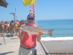 Garry Oliver, of Manteo, with a 24" puppy drum that bit a green Saltwater Assassin soft plastic off of Outer Banks Pier.