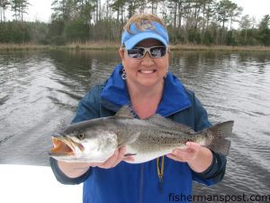 Michelle Lilly with a healthy speckled trout she hooked in a creek off the Neuse River while fishing with her husband, Capt. Gary Dubiel of Spec Fever Guide Service.