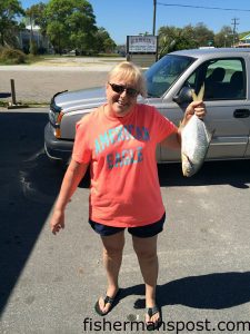 Elaine Bennett, of Fayetteville, NC, with a 19" pompano that bit shrimp in the Holden Beach surf.