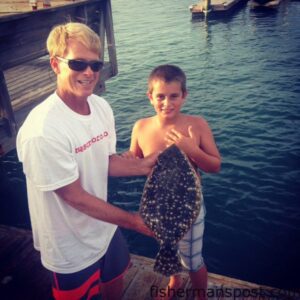 Duane Auman and Jack Steyskel with his first flounder, hooked on a 4" Gulp shrimp under a Banks Channel dock at Wrightsville Beach.