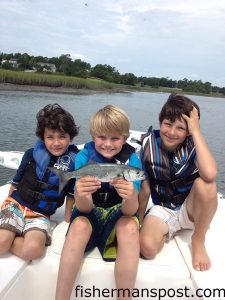 Korel (center) with a bluefish that he caught trolling a Clarspoon near the sea buoy outside Masonboro Inlet. He was fishing with ambassadors James (left) and Owen (right).
