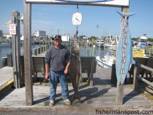 Loran O'Neal, of Avon, NC, with an 82 lb. cobia he hooked off Hatteras Inlet. Weighed in at Teach's Lair Marina.