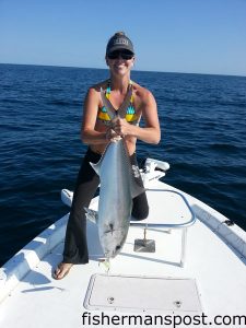 Shannon Clark with an amberjack she hooked on a topwater plug while fishing off Carolina Beach with her husband, Capt. Rennie Clark of Tournament Trail Charters.