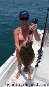 Shannon Clark with a flounder that she hooked while jigging some nearshore structure off Carolina Beach with her husband, Capt. Rennie Clark of Tournament Trail Charters.