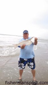 Tony Green, of Sophia, NC, with a red drum that struck a cut bait in the Holden Beach surf.
