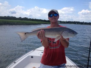 Mark Chenault, of Castle Hayne, NC, with his first red drum, a 25" fish that fell for a live mud minnow near Richs Inlet while he was fishing with his dad.