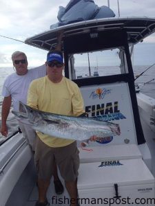 Mike Williams and Jason Tierney with the 33 lb. remains of a king mackerel after a barracuda clipped its tail while they were fishing the Got-Em-On King Mackerel Tournament aboard the "Final Approach."