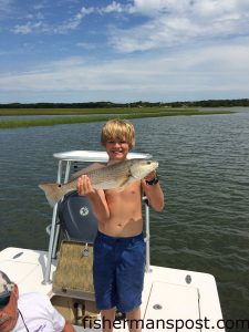 Bear Bozard with red drum he hooked in a Swansboro-area marsh while fishing with his mom and grandfather.