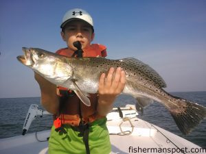 Noah Houston, of Concord, NC with a stout speckled trout that bit a live bait near Southport while he was fishing with Capt. Greer Hughes of Cool Runnings Charters.