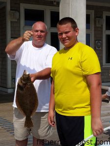 Richard and Zeb Wilcox, of Wilkes County, NC, with a 22" flounder they hooked form Jennette's Pier.