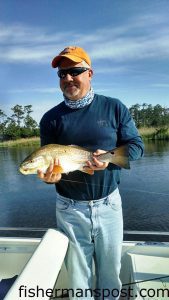 Stuart Creighton with a 24" puppy drum that bit a D.O.A. CAL soft plastic in a creek off the lower Neuse River. He was fishing with Capt. Dave Stewart of Knee Deep Custom Charters.