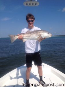 Chris Williams, from PA, with a red drum that inhaled a live menhaden on a Carolina rig in Little River Inlet while he was fishing with Capt. Mark Dickson of Shallow Minded Inshore Fishing Charters.