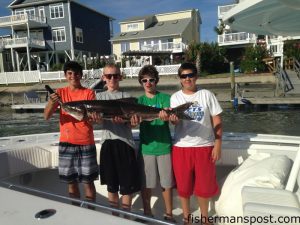 Austin Swett, Garrett Williams, Holden Carroll, and Matt Elliott, of Ocean Isle Beach, with a 27 lb. cobia that bit a live blue runner off Little River Inlet while they were fishing with Kay Carroll on the "Pharmasea."
