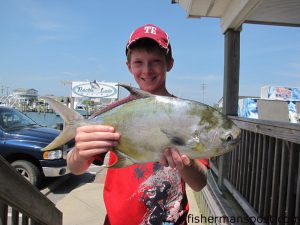 Matthew Golden, of Salem WV, with a 3 lb., 1 oz. pompano he hooked while surf fishing at Hatteras Village. Weighed in at Teach's Lair Marina.